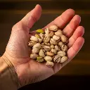 Firefly A person holding a small handful of unsalted pistachios in their cupped palm, giving a clear (2).webp